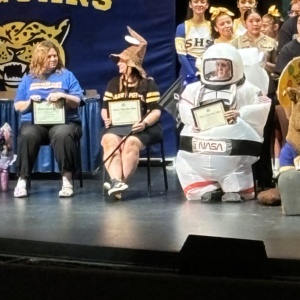 Picture of Ms. McCarthy teacher of the year. Sitting in the auditorium receiving her award.