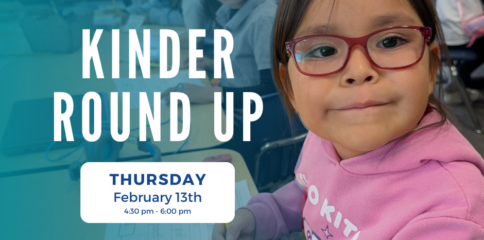 Student smiles while practicing wriitng with text in the front says Kinder Round Up, Thursday Feb 13th, 2025.