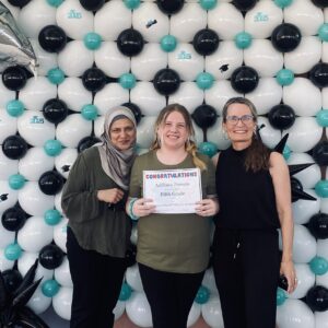 SDPA 8th grade promotion of two teachers and a student taking a picture.