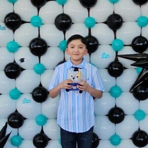 SDPA 5th grader taking a picture with a little stuff animal.