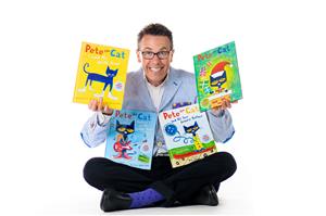 Author Eric Litwin holding his Pete The Cat Books