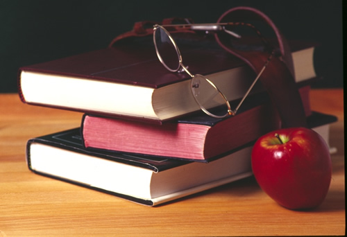 stack of books with an apple 