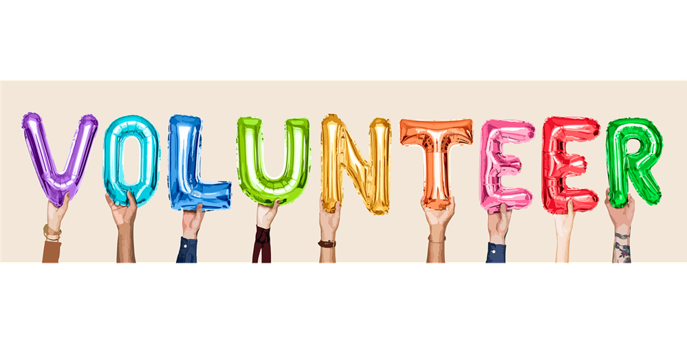 Hands raising letters that spell out VOLUNTEER