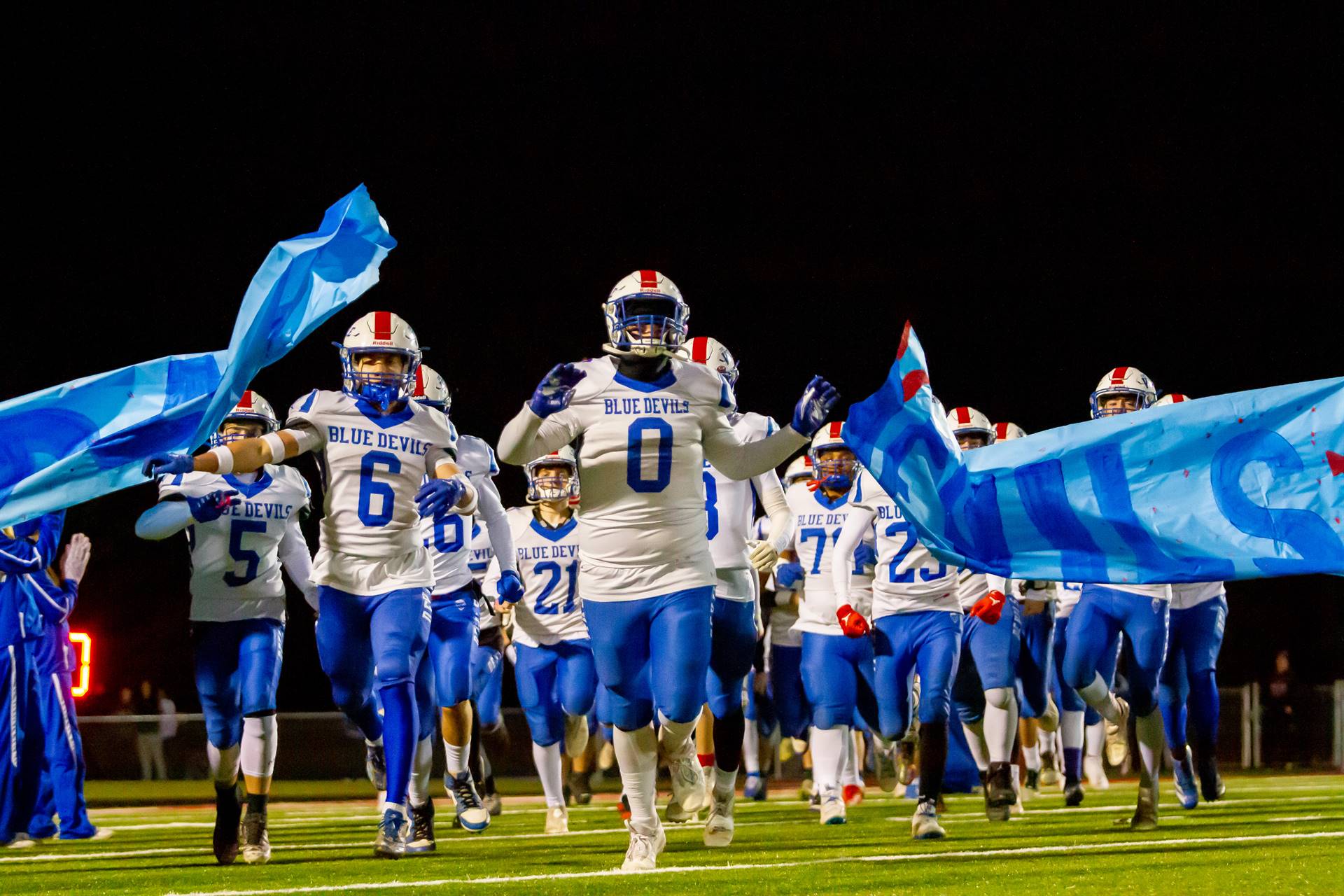 The 2024 Sharpsville Blue Devil varsity football team runs onto the field