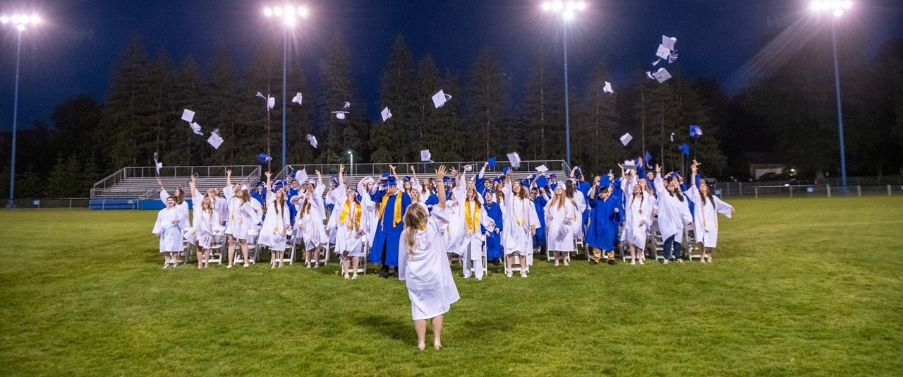 Graduates of the Class of 2024 toss their caps at the end of the commencement ceremony