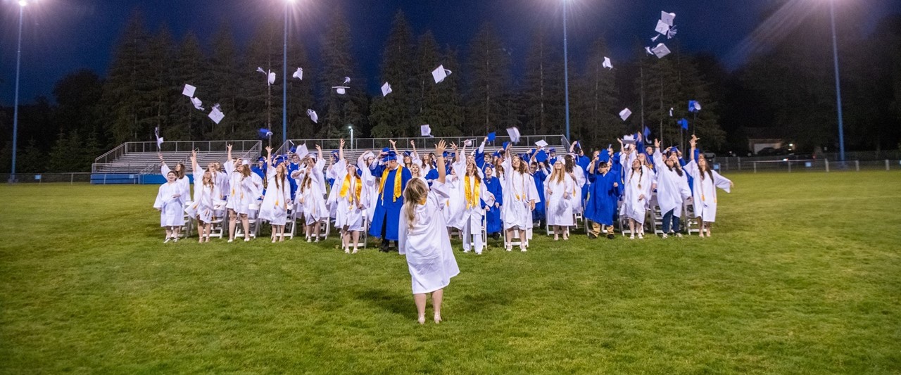 Graduates of the Class of 2024 toss their caps at the end of the commencement ceremony
