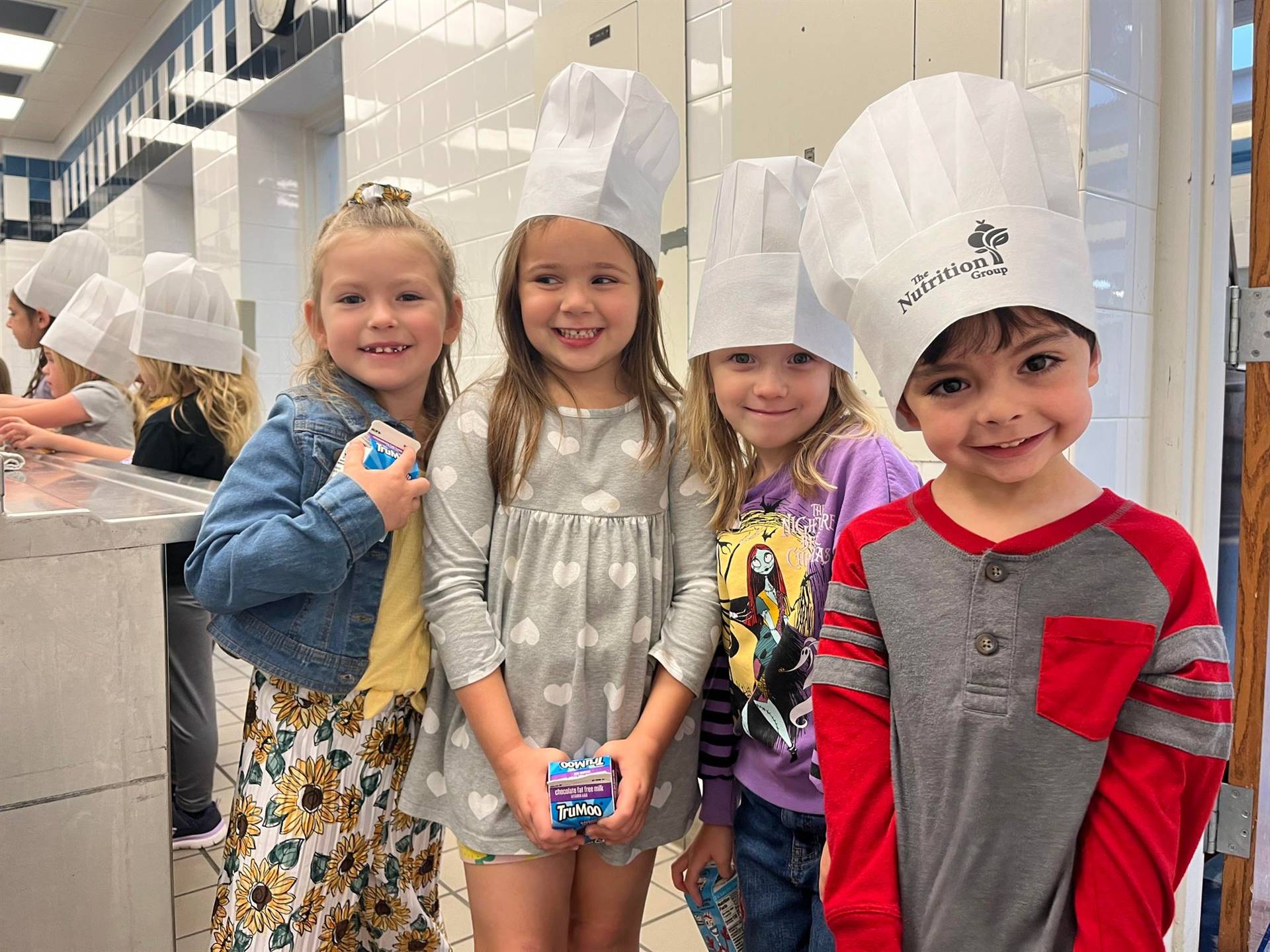 Elementary students wearing chef hats