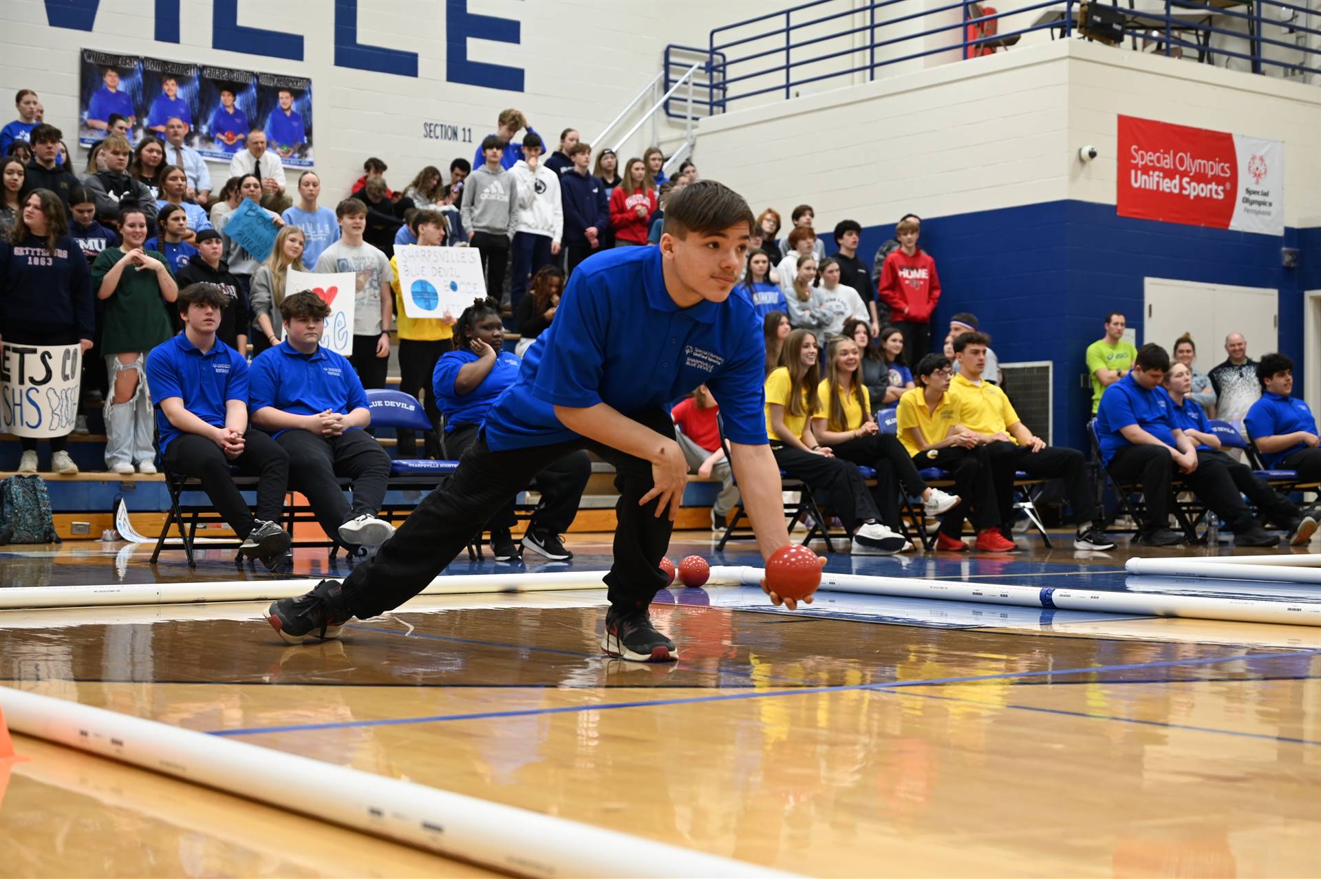 Blue Devils Bocce team takes part in a home game live in front of a packed gymnasium of their peers