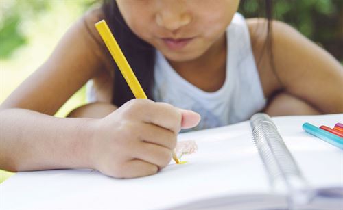 student writing in notebook