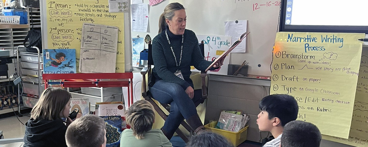 Elementary Principal Mrs. Tammaru reads to the class