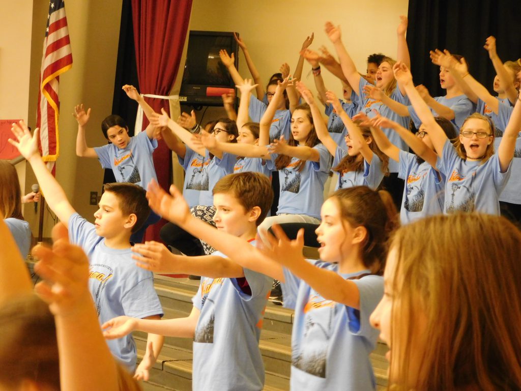 Group of students sing in a group