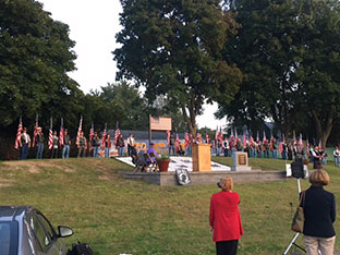 group of people gathered at the Hill of Heroes for a 9-11 remembrance ceremony