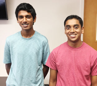 two high school students pose and smile