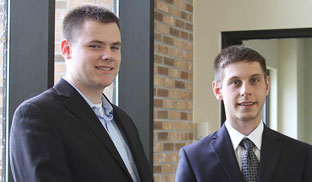 Craw and Altman stand together where dress suits