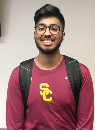 high school student smiling wearing his south colonie shirt and a backpack