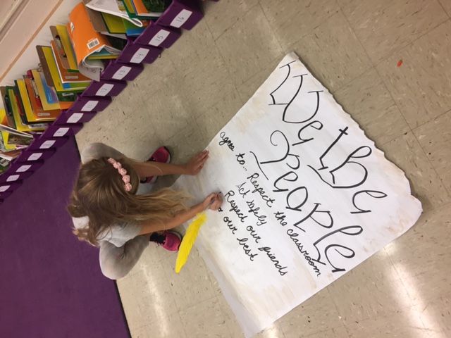 girl signs class constitution