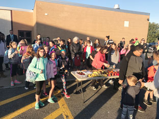 Sand Creek families gather outside the school for refreshments