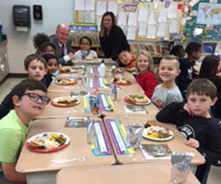 students gather for dinner in the classroom