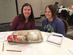 two science teachers sitting together at a table