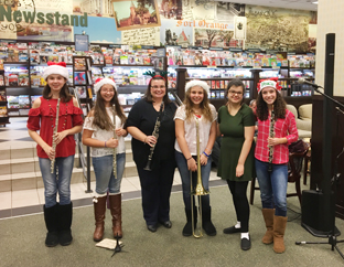 five female band members pose with their instruments