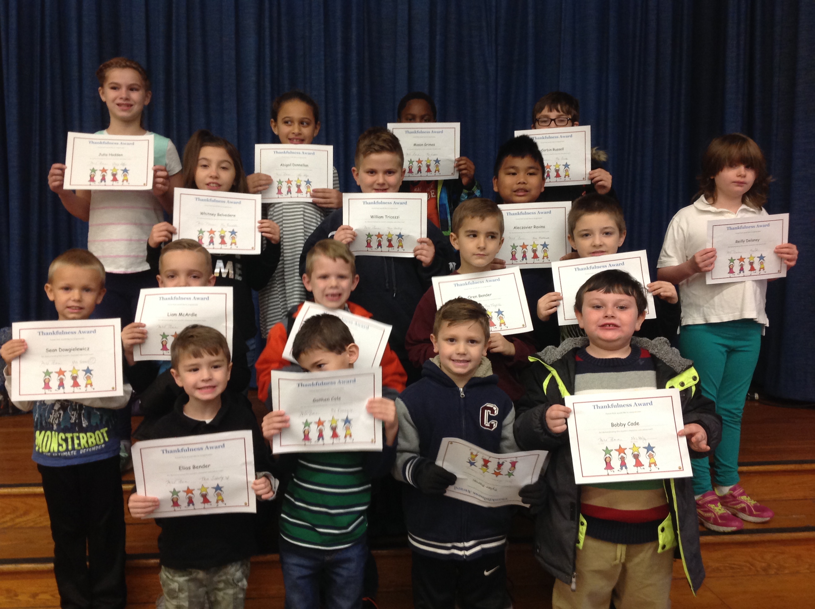 group of students holding up their award certificates