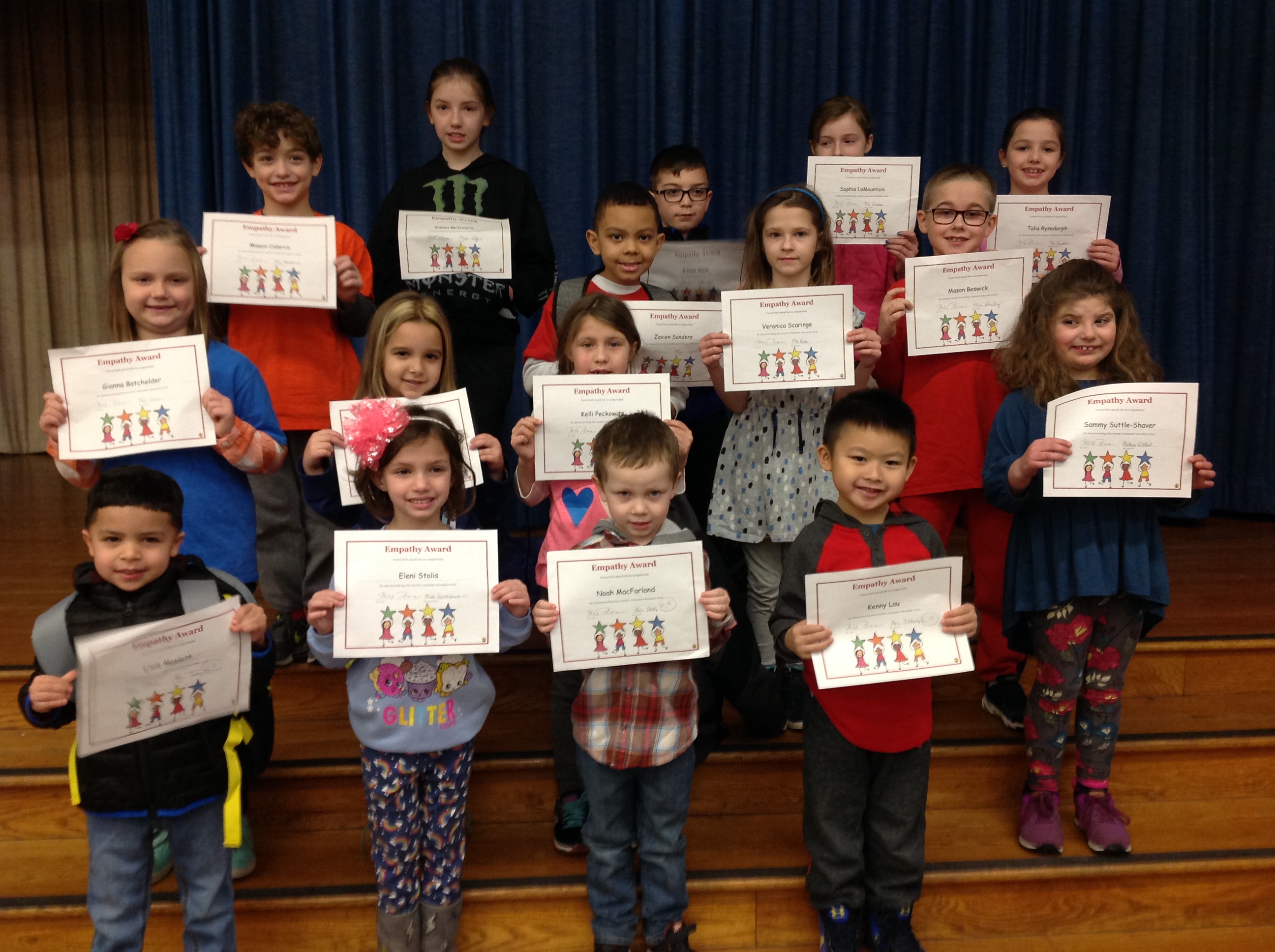 group of students show off their award certificates