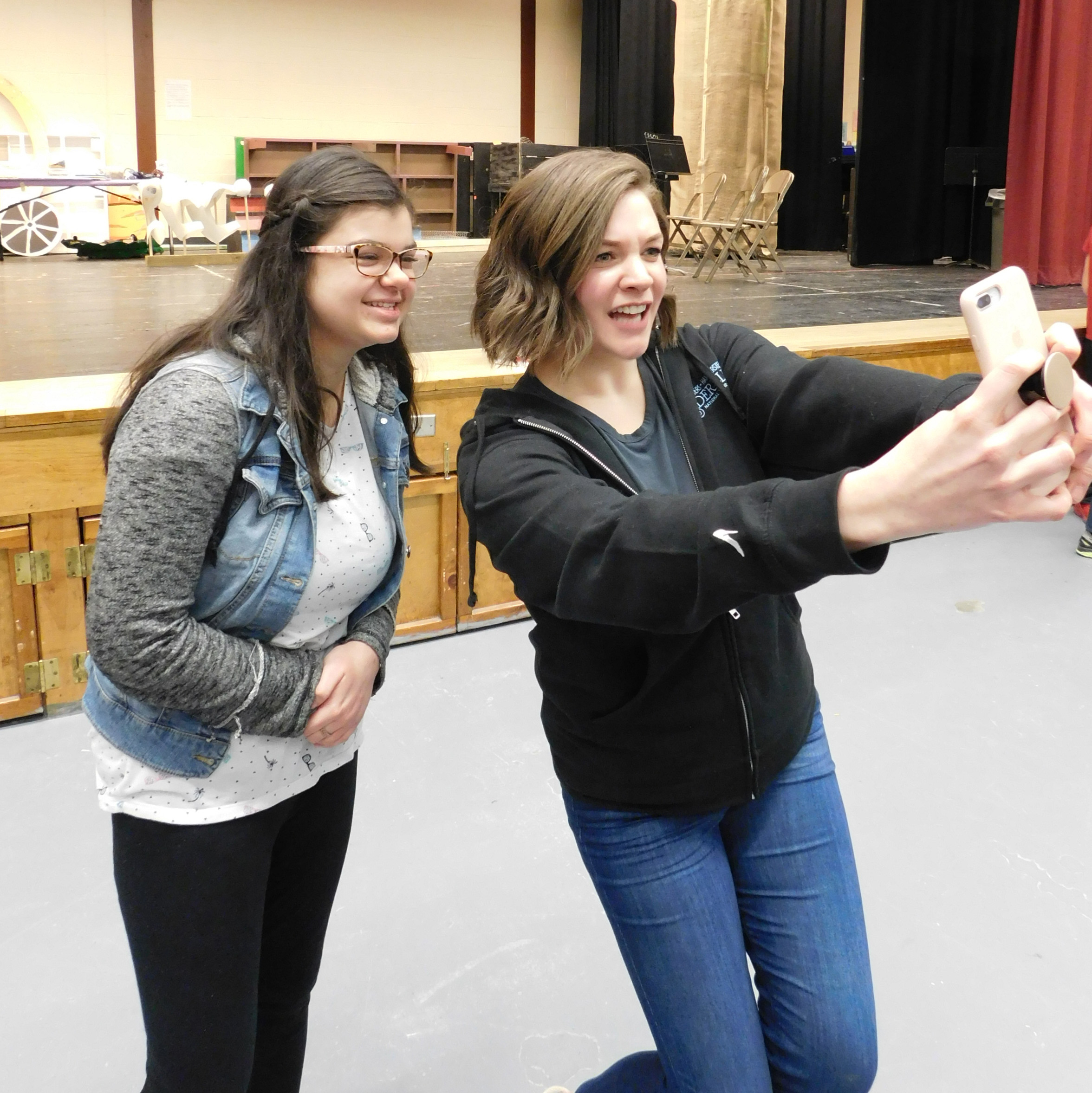 professional actor takes a selfie with a middle school student