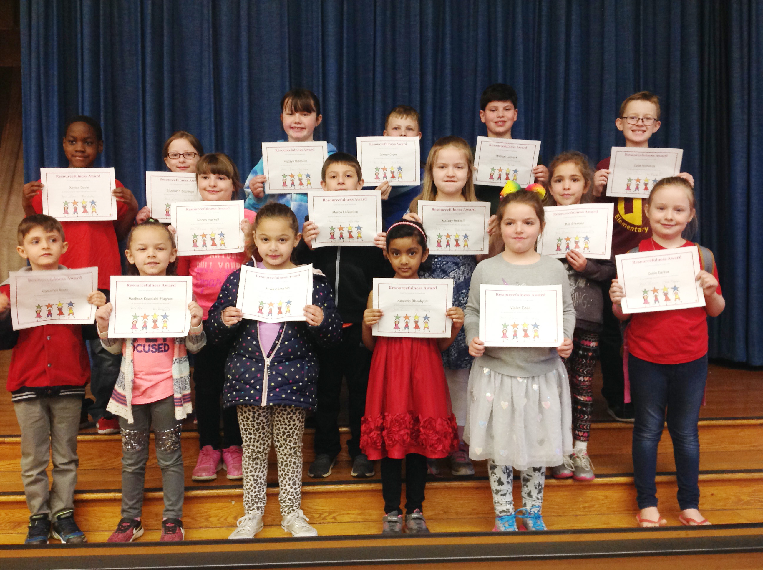 group of student hold up their award certificates