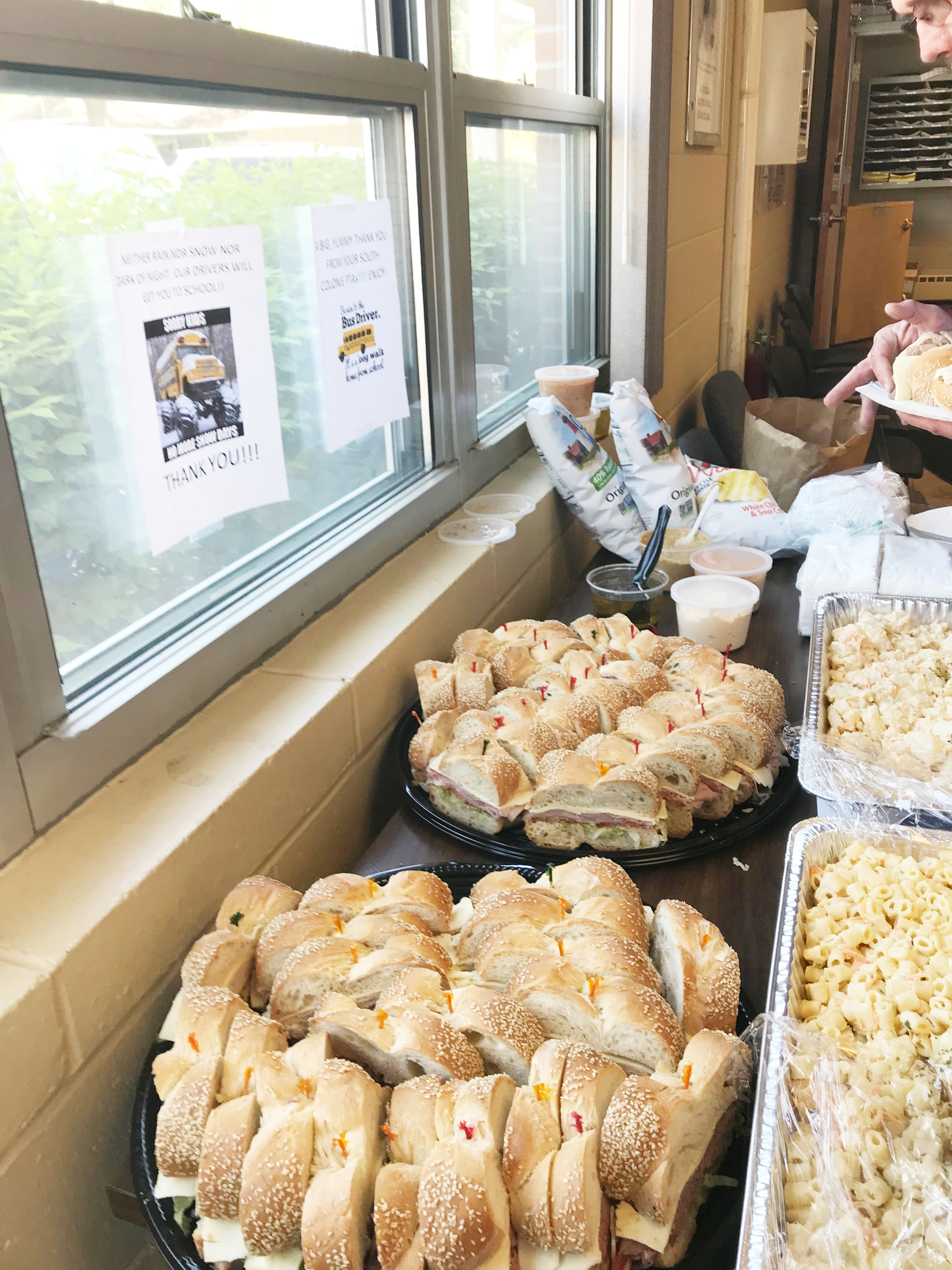 sandwich and salad spread on table for bus drivers