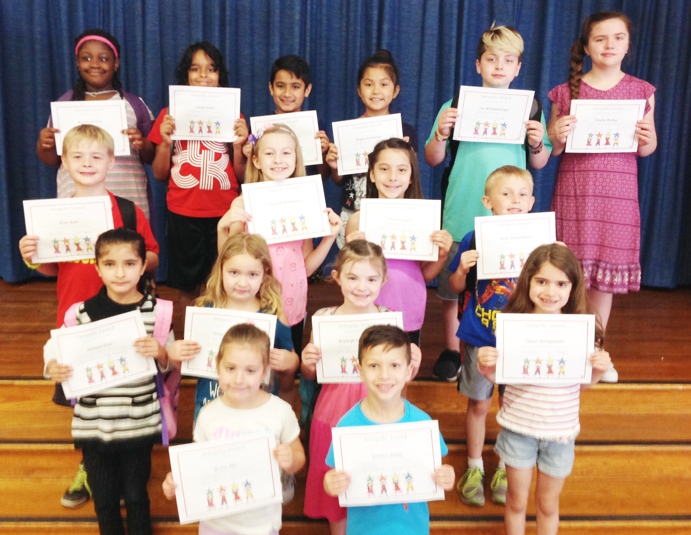 group of student hold up their award certificates