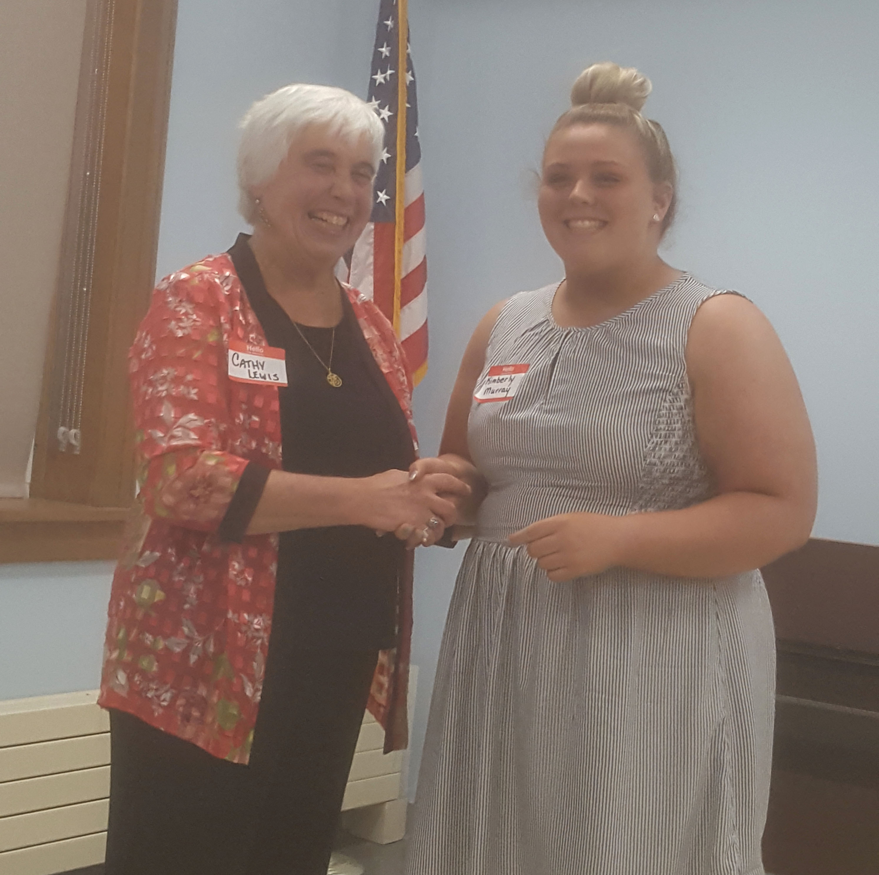 woman presents award to a high school student