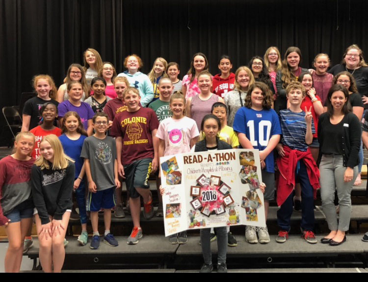 group of students hold up their fundraising big check