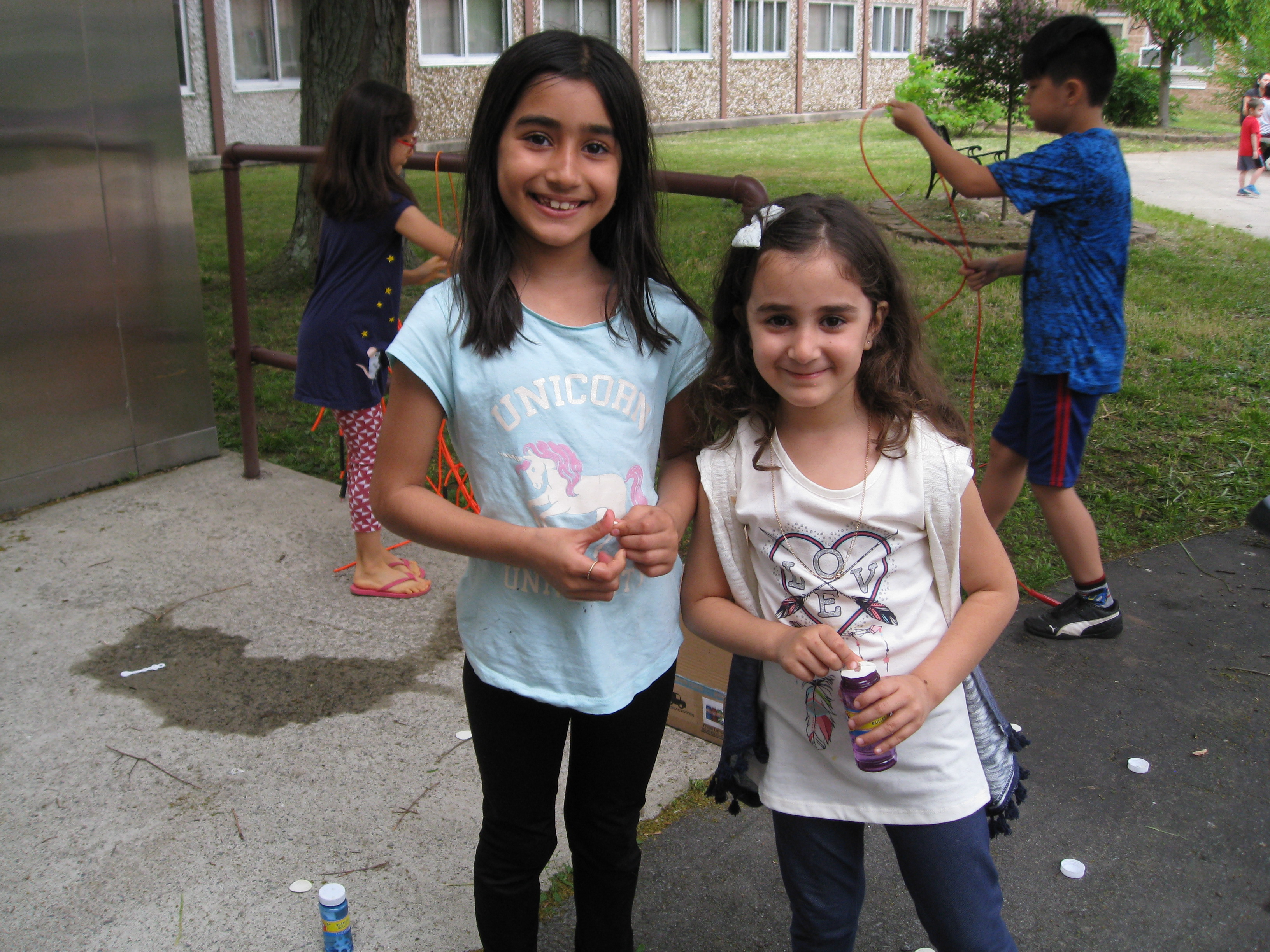 two girls pose on the playground