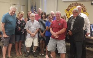 group of bus drivers stand with the school board members