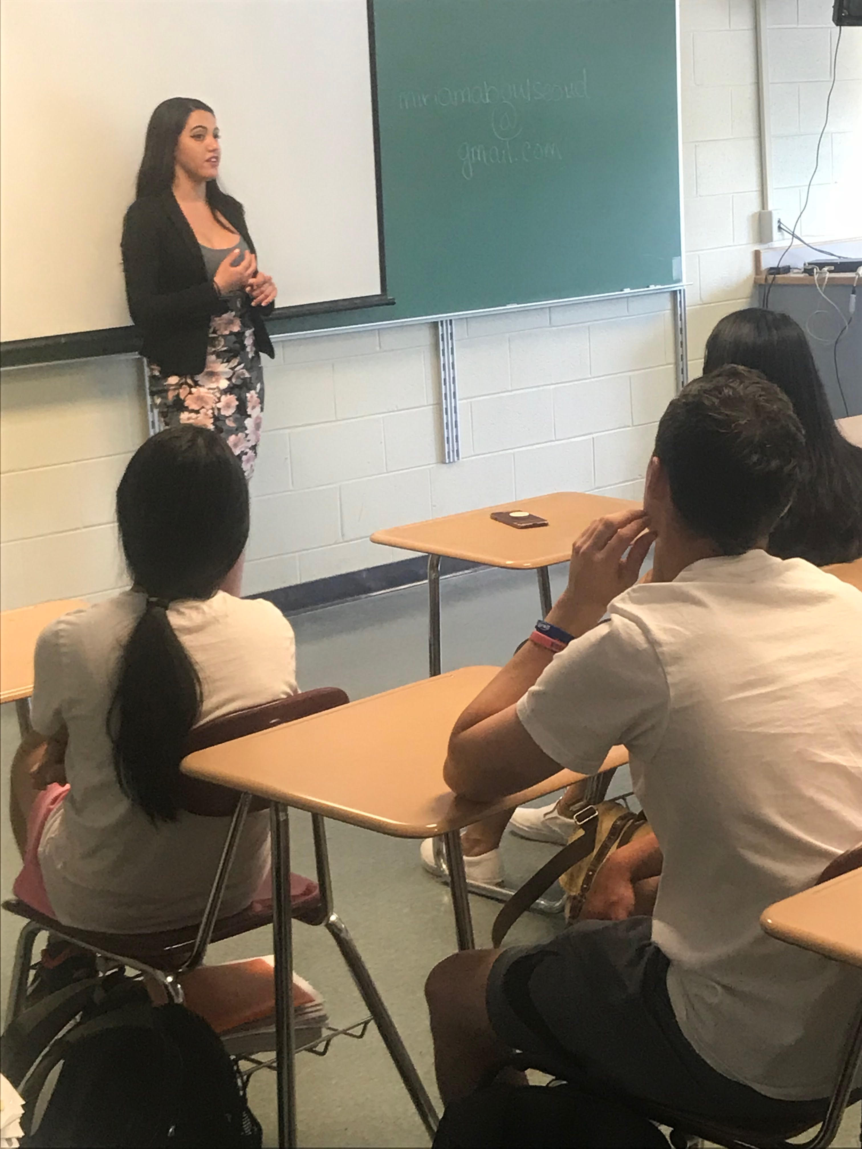 woman presents in front of class