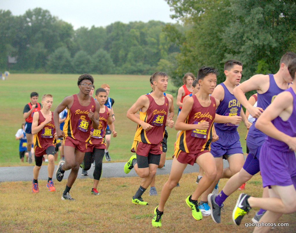 boys running cross country on street