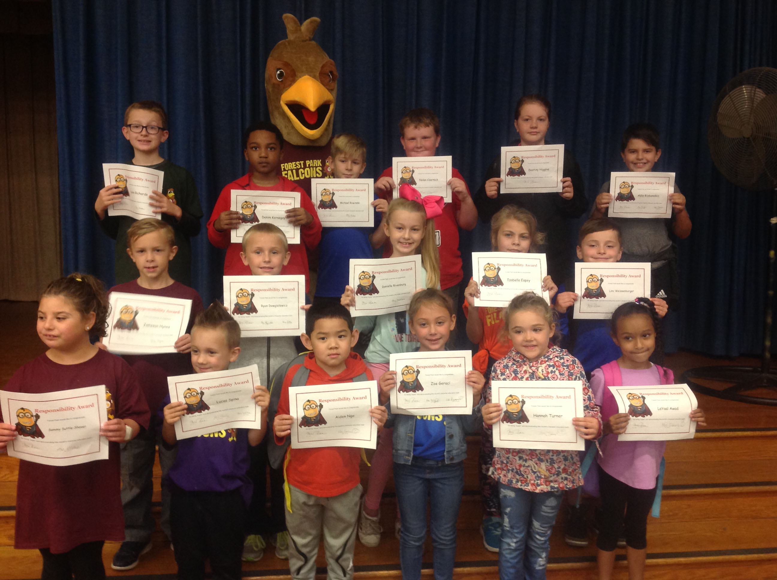 group of young students holding their award certificates