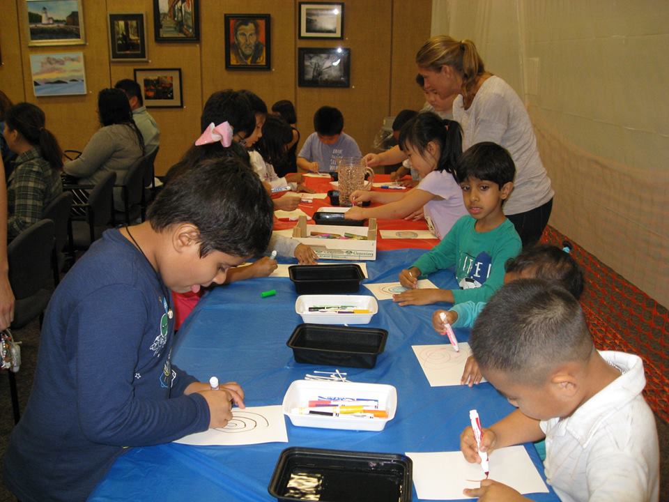 group of students work on a project at a large table