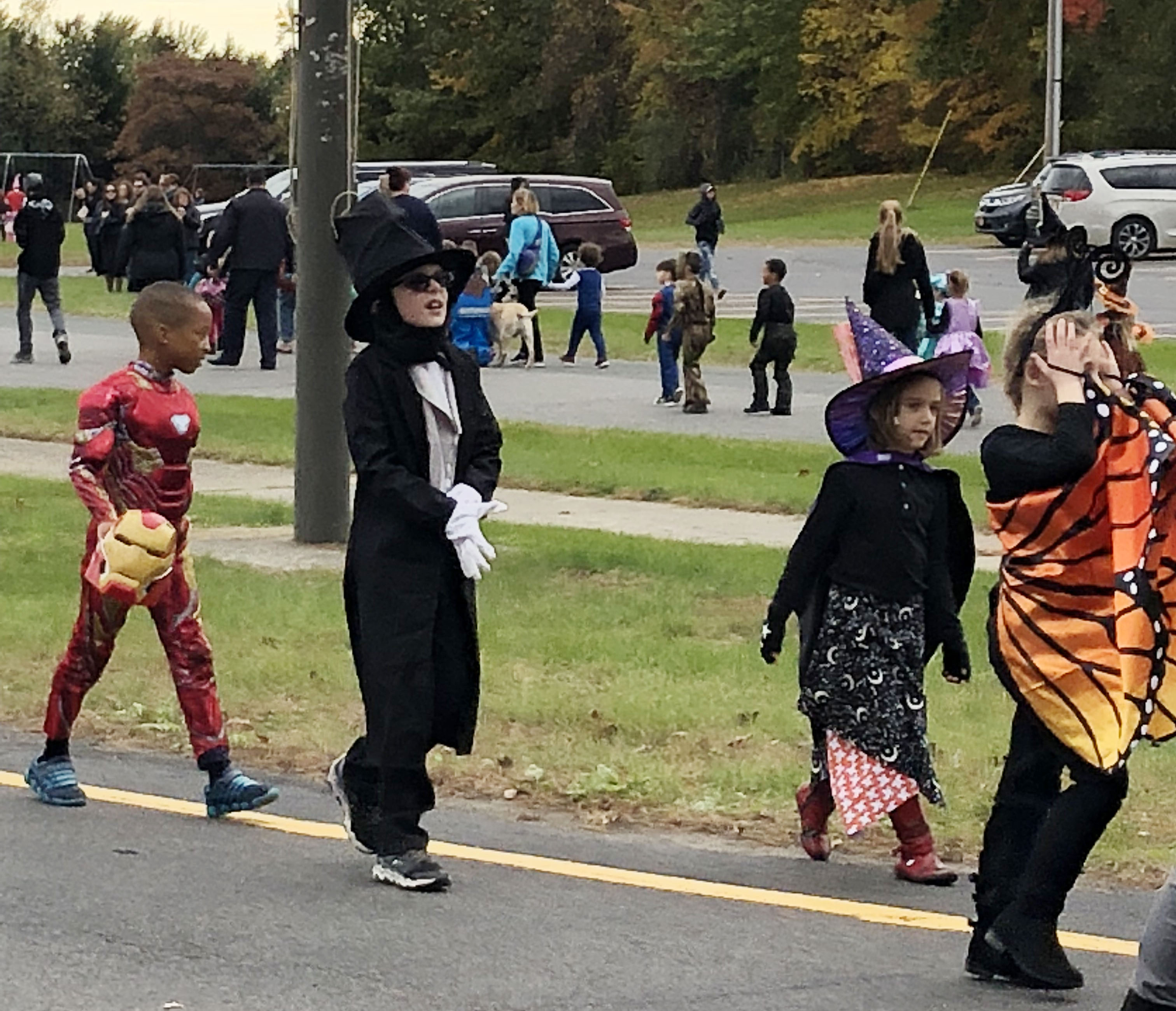 students march in Halloween costumes