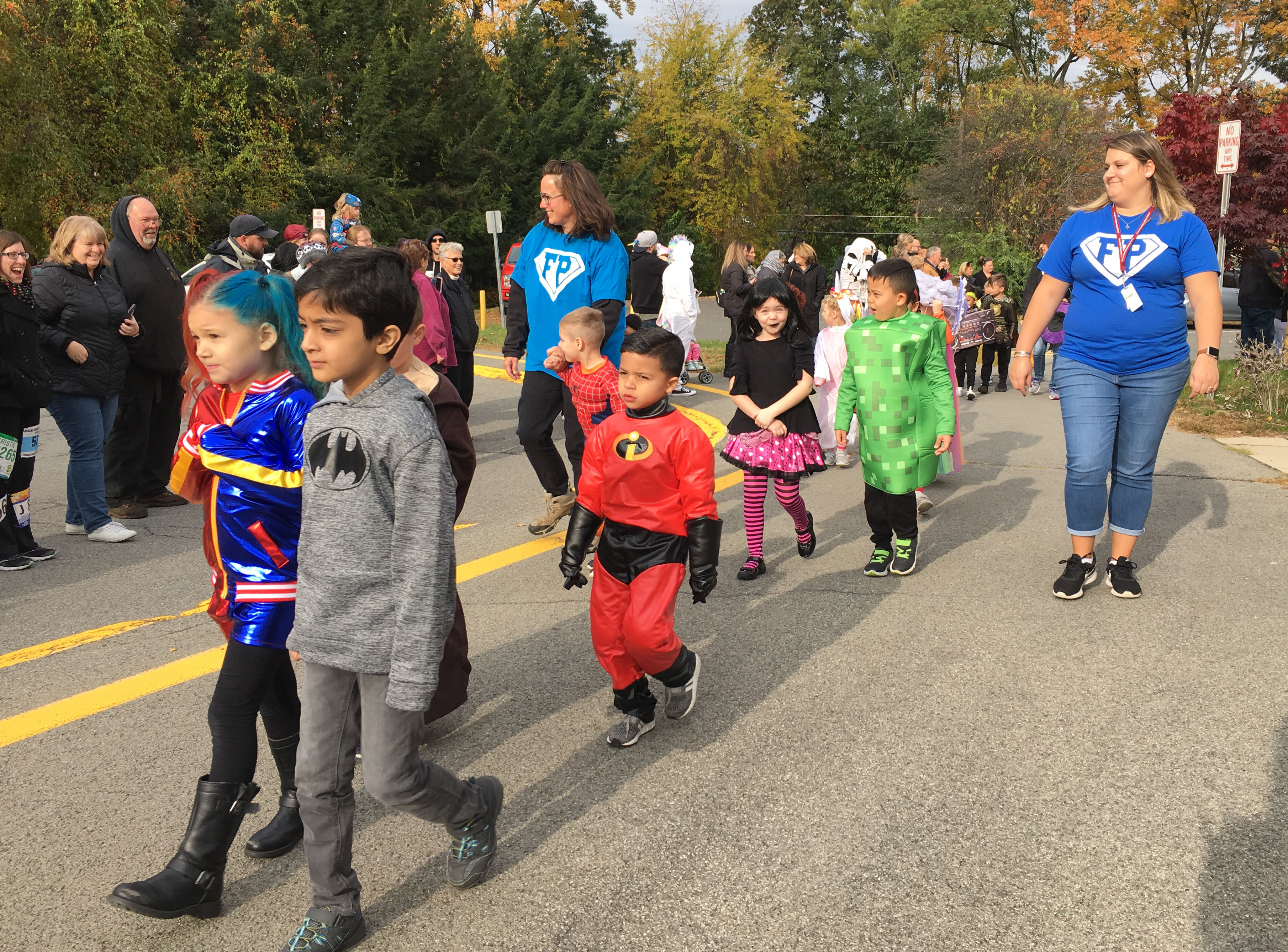 children march in a halloween parade in costume