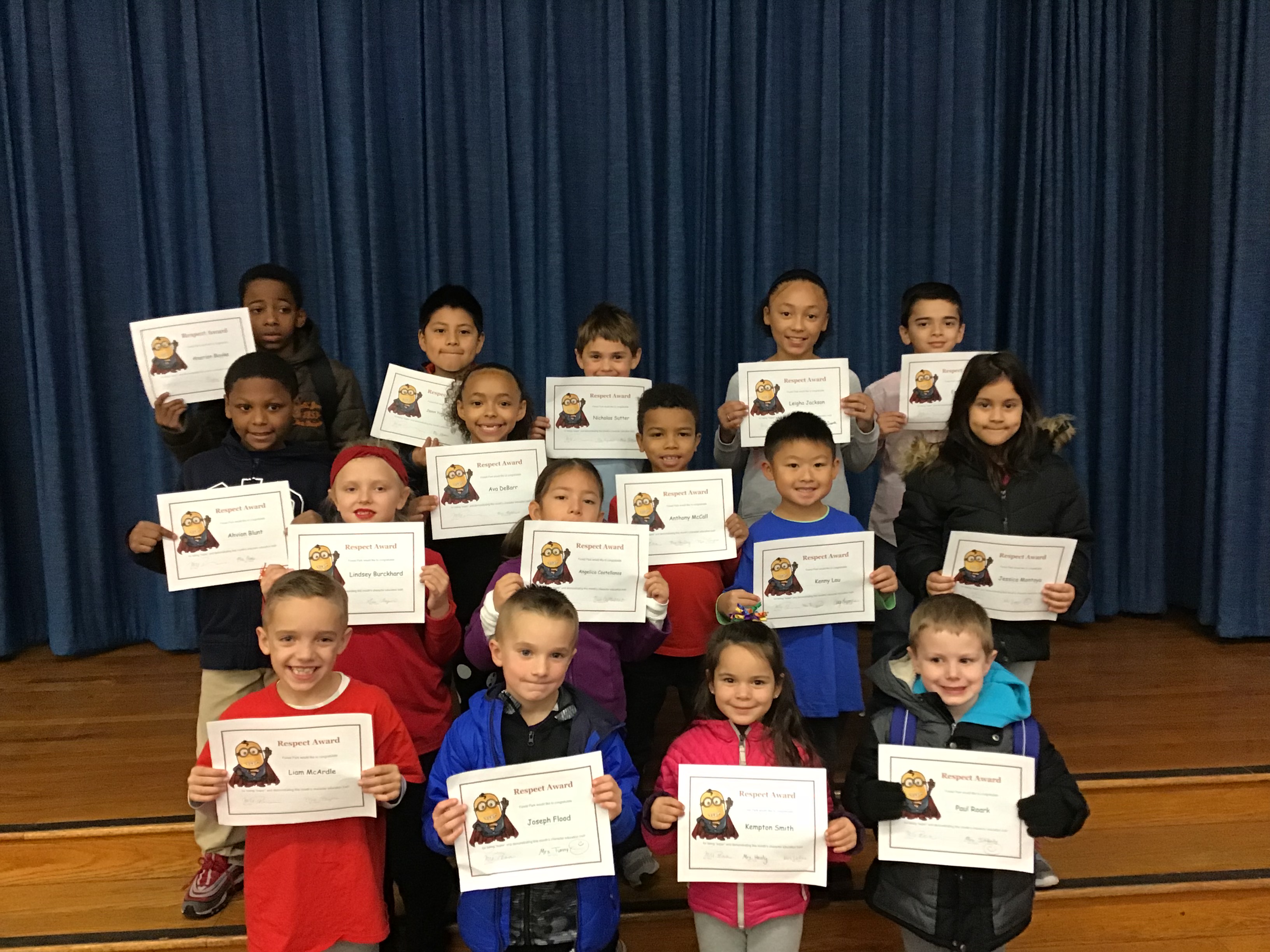 group of young students hold their award certificates