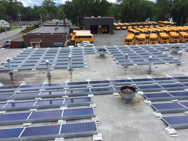 view of solar panels mounted on room of the bus garage