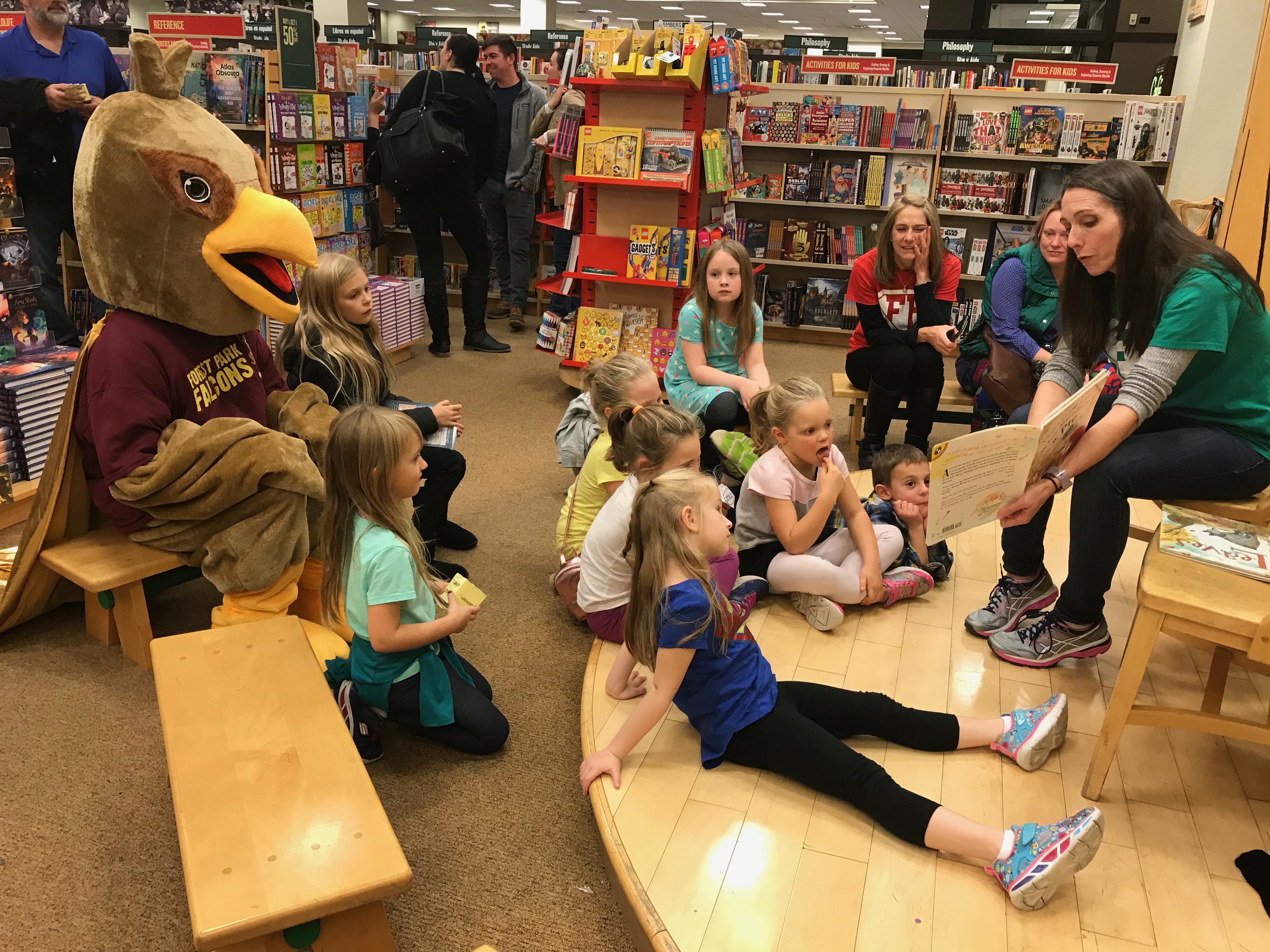 teacher reads to group of students