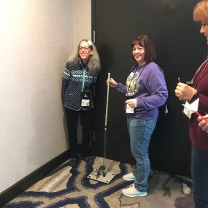 teachers work with a long handled rocket