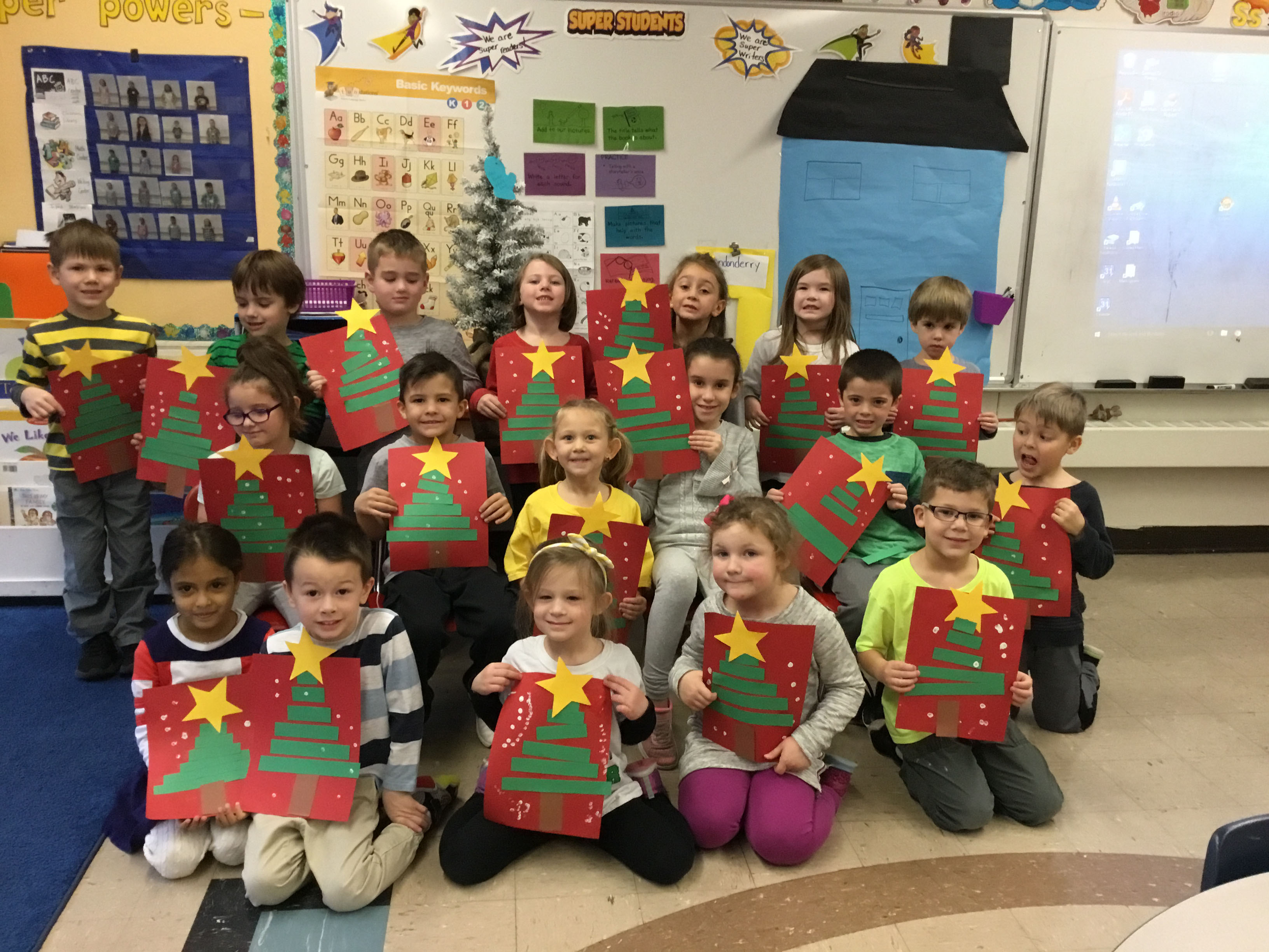 group of kindergartners show off their star drawings