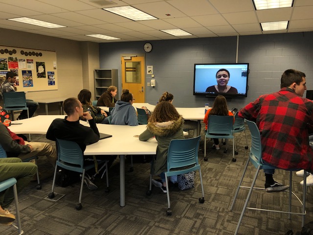 students in a classroom with a tv monitor 