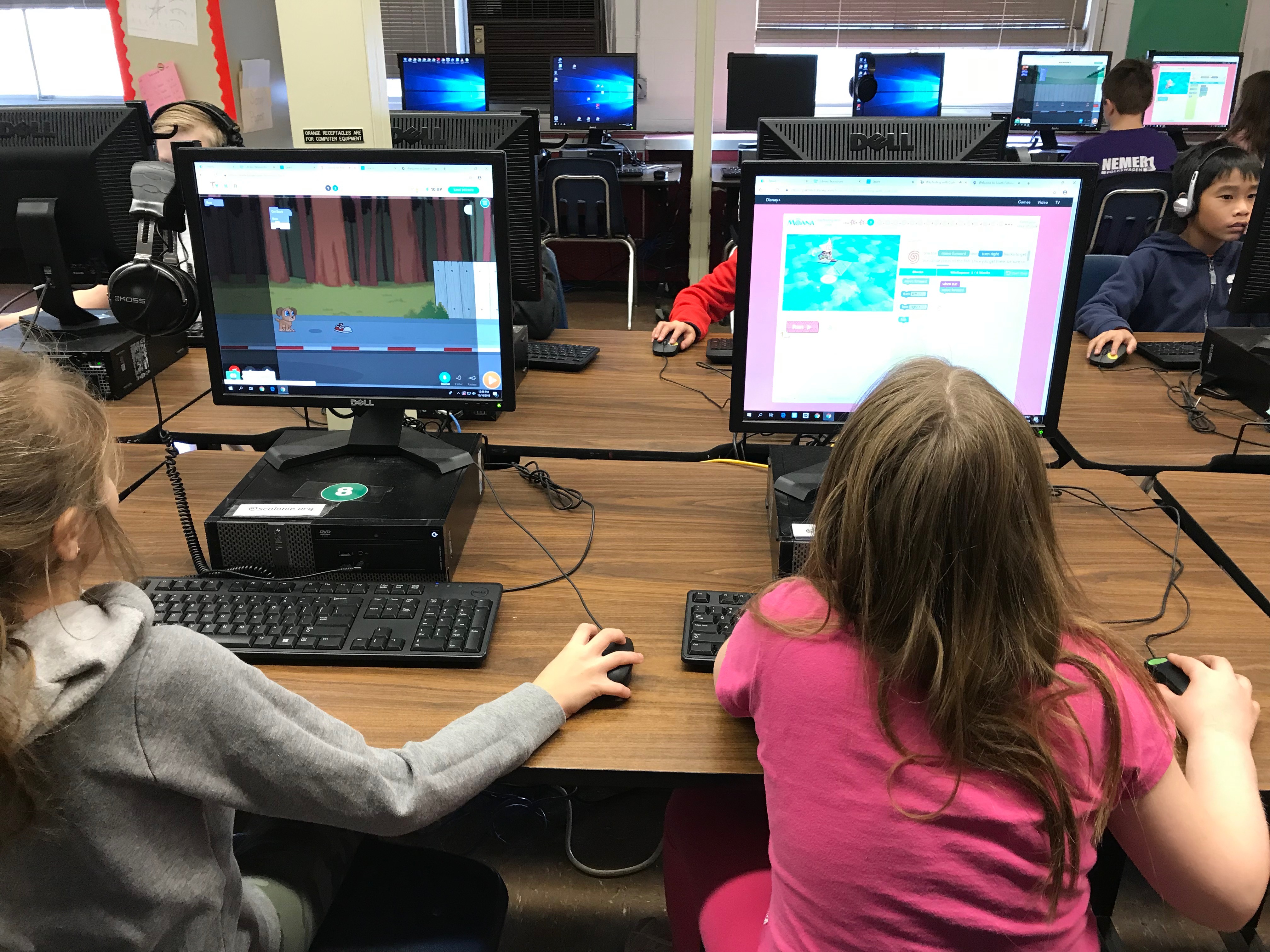 two girls work on computers