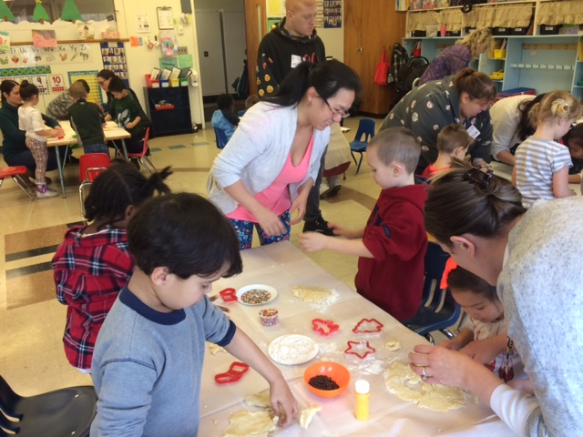 children and parents make cookies together