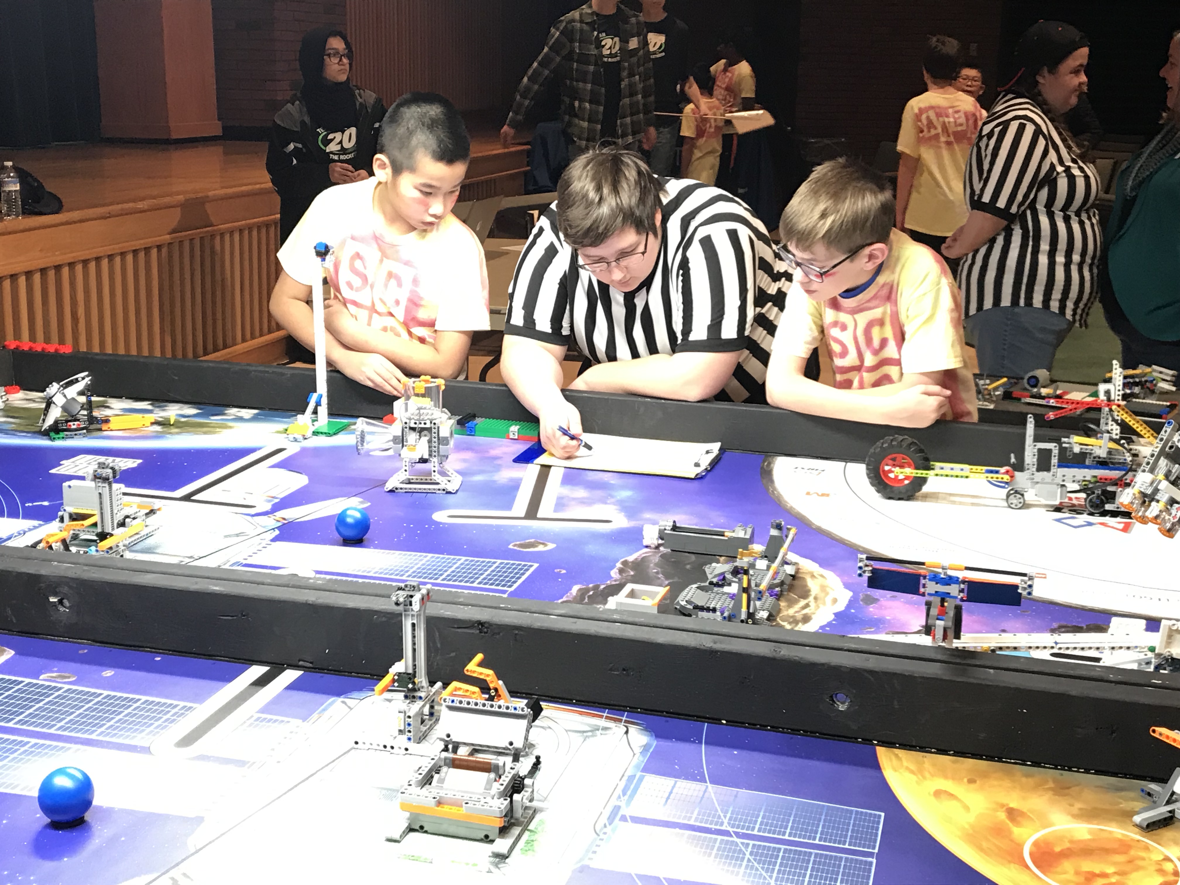 2 students and a referee at a lego table