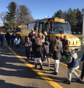 students march to the school bus